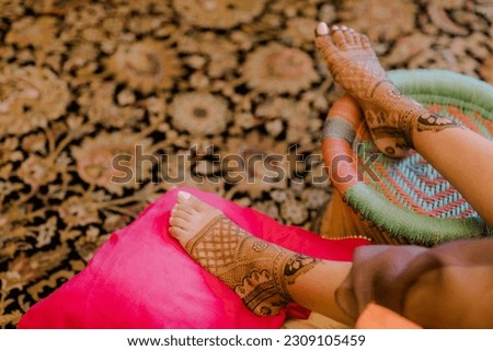 Artist applying henna tattoo on women . Mehndi is traditional Indian decorative art. Close-up