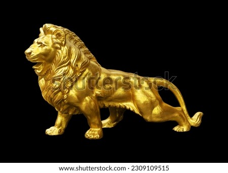beautiful gilded lion statue on a black background. Works of art Royalty-Free Stock Photo #2309109515