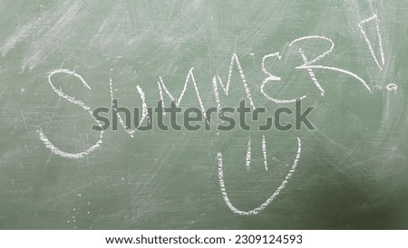 Green blackboard with summer written on it.