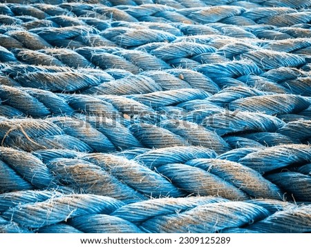 Nylon blue towing rope prepared and laying ready for towing operations on aft station of cargo vessel