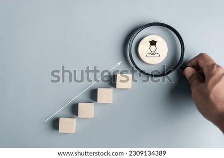 Steps of education leading to success goal. Taking strategic steps towards graduation. Career path and first for business, Graduation achievement goals concept. Graduation cap into Magnifying glass. Royalty-Free Stock Photo #2309134389