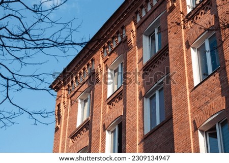 Modern apartment building for residential living in red brick stone. High quality photo