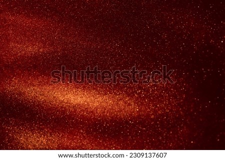 Magic Galaxy of gold dust particles in red fluid. Golden glitter particles stains and liquid flows on a dark red background with burgundy hues. Royalty-Free Stock Photo #2309137607