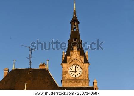 Clock (hands are at 9 o'clock) and roof of old building of harbour-office of Strasbourg port, built in 1899 by architects K.Ott and G.Obertuer. Example of in neo-gothic style of architecture in France Royalty-Free Stock Photo #2309140687
