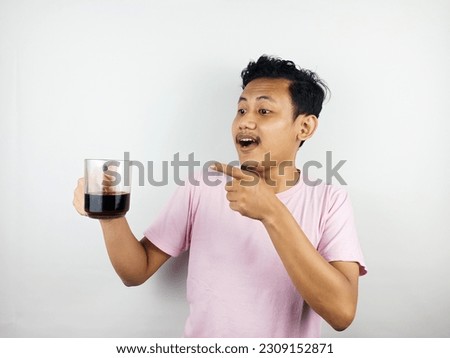 Asian man holding a cup of delicious coffee. Taste good coffee. Advertising.