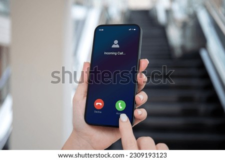 woman hands hold phone with incoming call on screen background of stairs in office Royalty-Free Stock Photo #2309193123