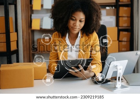  African Woman hand using a laptop, smartphone and tablet and writing notebook at the office of her business online shopping. In home with virtual icon 

