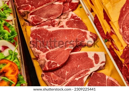 Horizontal row of raw t-bone steaks asset Royalty-Free Stock Photo #2309225441