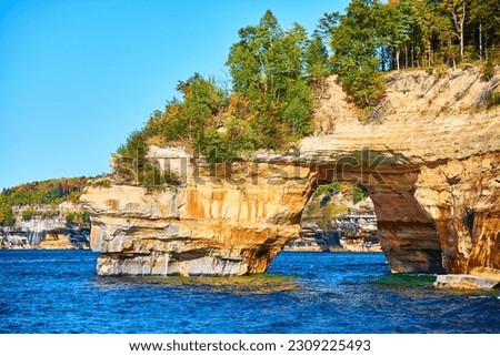 Sapphire waters in Lake Michigan with cliff archway at Pictured Rocks National Park