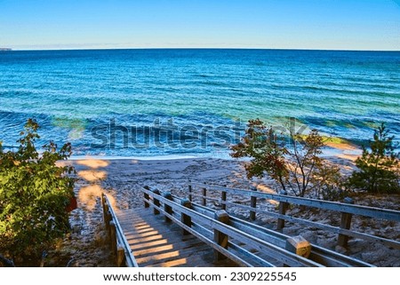 Blue lake or ocean with stair walkway down to shore