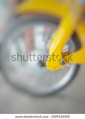 A blurred image of a classic motorcycle wheel.