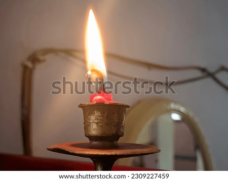 Closeup of burning red candles on the altar where Chinese people pray