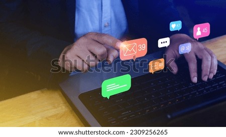 People using social media and digital online marketing concepts on laptop with icons such as notifications, messages, comments on the smartphone screen.