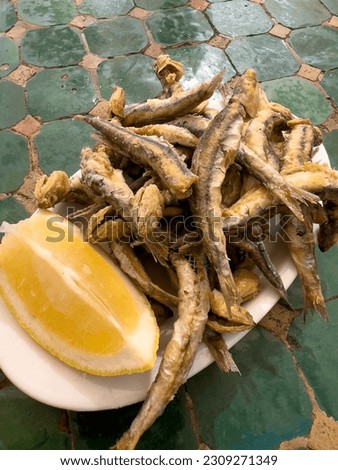 A dish of BOQUERONES FRITOS, breaded and fried fishbait, typical tapas style food in Ibiza and Spain. Balearic cuisine, crunchy and savory starter.