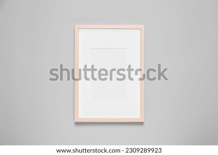 Empty photo frame on light background, top view. Space for design