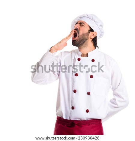 Chef yawning over white background