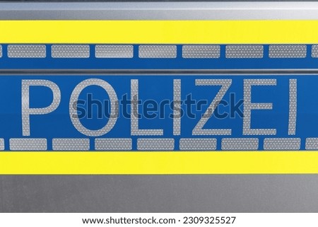 picture of the writing of the German word of police on a German police car
