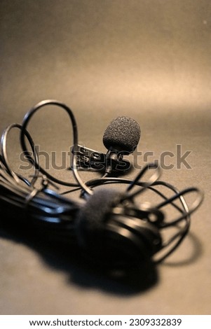 Lavalier mic close up with black background