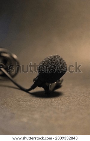 Lavalier mic close up with black background