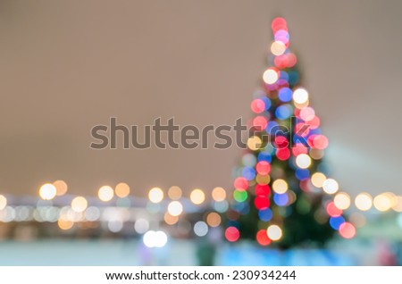 Defocused christmas tree silhouette with blurred lights