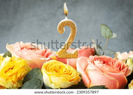 Gold glitter number 2 celebration candle with flowers