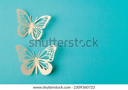 Paper butterfly carve on a green background with empty space.