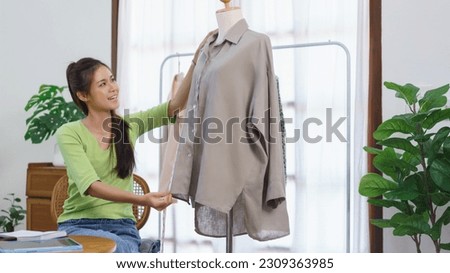 Fashion clothes online concept, Female blogger present new dress and measure length size of shirt.