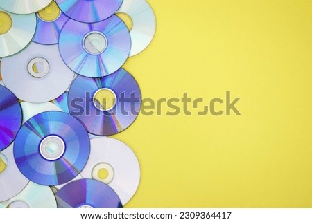 Lots of old CDs are laid out as a background. Bright background. Vintage. Royalty-Free Stock Photo #2309364417