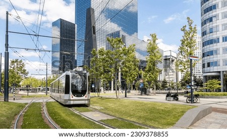 Tram in the city center, public transportation, modern buildings background, sunny day in town Royalty-Free Stock Photo #2309378855