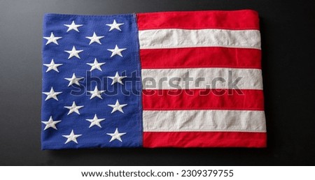 American flag folded on black abackground, top view. US America National Holiday, Memorial and Independence day