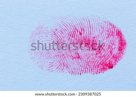 Red fingerprint,Red fingerprint on white paper,Bloody fingerprint as background, macro. Imprint of index finger Royalty-Free Stock Photo #2309387025