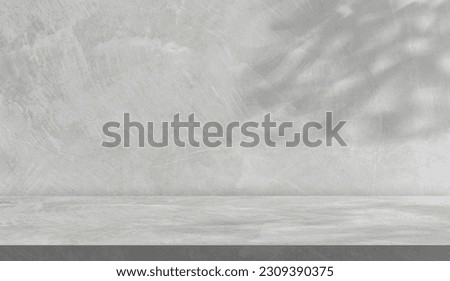 Empty Grey cement wall room interior background and concrete floor shelf with shadow leaves well display product background and text present on free space backdrop  