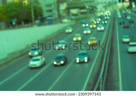Defocused photography of the traffic in the city Moscow in summer sunset. Big traffic at highway. Road is filled out by cars. Rush hours. Lifestyle of big city concept. Front views