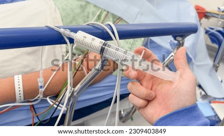 Hands holding syringe and hospital drugs symbolize medical care, precision, treatment, and the critical role of anesthesia in healthcare