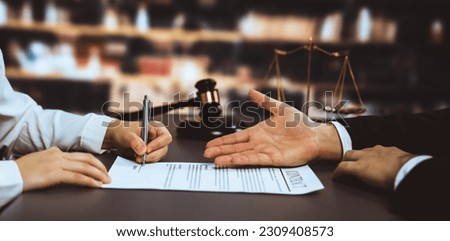 Lawyer signing contract, professional lawyer in law firm library drafting legal document or contract agreement ensuring lawful protection for client's dispute as fairness advocate concept. Equilibrium Royalty-Free Stock Photo #2309408573
