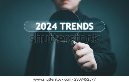 2024 Trends, Business, Strategy, Marketing Concept. Businessman holding magnifier with 2024 Trends business, forecast new Trends, new campaign, target Marketing, goal, new year's business marketing.