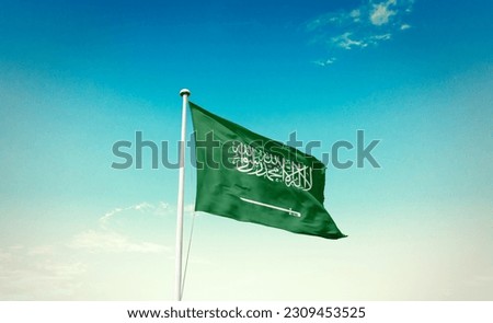 Waving flag of Saudi Arabia in beautiful sky. Saudi Arabia flag for independence day. Royalty-Free Stock Photo #2309453525