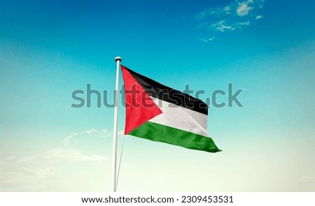 Waving flag of Palestine in beautiful sky. Palestine flag for independence day.