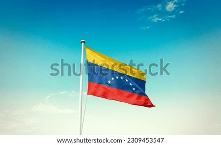 Waving flag of Venezuela in beautiful sky. Venezuela flag for independence day. Royalty-Free Stock Photo #2309453547
