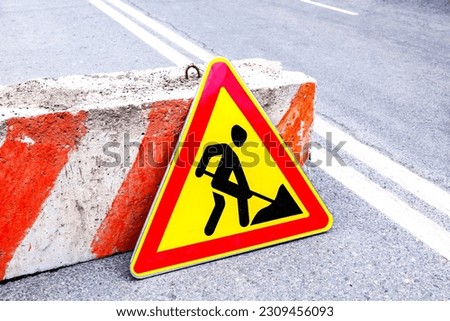 Road works sign at the city street. Carrying out construction and repair work in the city
