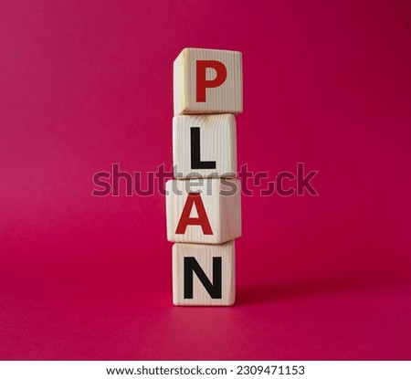 Plan symbol. Concept word Plan on wooden cubes. Beautiful red background. Business and Plan concept. Copy space.