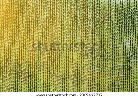 Background, texture of mesh fabric outdoors. Close-up photo.