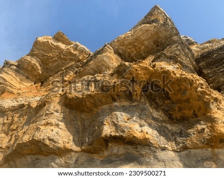 The yellow sandy volcanic coast , Awesome high dolomitic walls, rich in pinnacles and spiers, blue sky and mountain peak, Beautiful pictures taken in valley, Summer mountain view,  Beautiful sunny day
