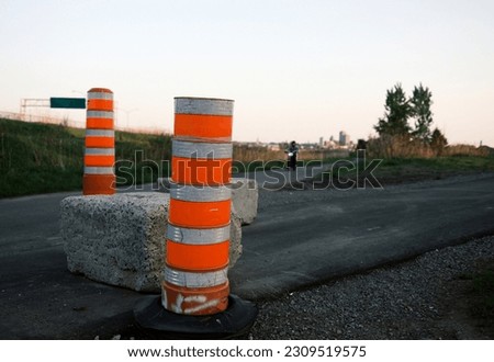 Traffic cones on a road in the evening light. Road safety concept.