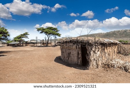 Africa. Masai Mara. Reservation in Kenya. The Masai Mara tribe. An old hut made of clay and twigs.  The house is made of clay. Royalty-Free Stock Photo #2309521321