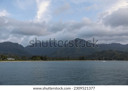 Scenic Panoramic View of Hanalei Bay, Hawaii - This breathtaking high-resolution stock photo captures the true essence of tropical paradise. The iconic Hanalei Bay in Kauai is majestically presented.