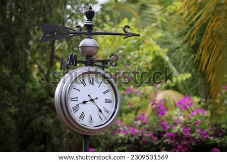 clock in the park in retro arabesque