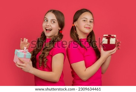happy kids with present boxes on red background