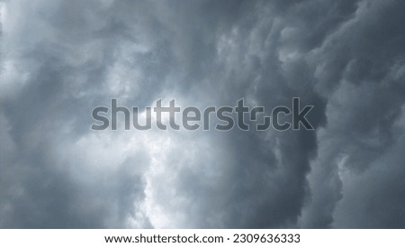 A moody and dramatic shot of stormy clouds and lightning strikes, evoking a sense of power and natural beauty, ideal for use in editorial, travel or landscape photography projects.