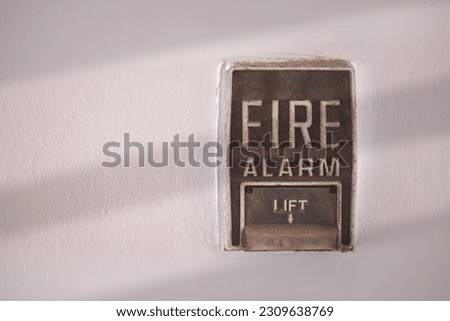 Fire Alarm switch on building wall used when in case of fire is safety building or factory concept.